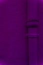 vertical semi smooth dark blue-magenta stucco wall textured with same color pipe Royalty Free Stock Photo