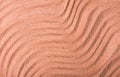 Background with abstract texture, ridges on the surface of sand, close-up, top view, coral color, horizontal, without