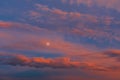 Background of amazing mystery red and yellow clouds illuminated by rays of evening sun on blue sky at sunset Royalty Free Stock Photo