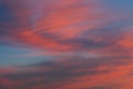 Background of amazing mystery red and yellow clouds illuminated by rays of evening sun on blue sky at sunset Royalty Free Stock Photo