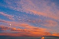 Background of amazing mystery red and yellow clouds illuminated by rays of evening sun on blue sky at sunset Royalty Free Stock Photo