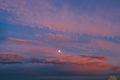 Background of amazing mystery red and yellow clouds illuminated by rays of evening sun on blue sky at sunset Royalty Free Stock Photo