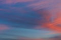 Background of amazing mystery red and yellow clouds illuminated by rays of evening sun on blue sky at sunset Royalty Free Stock Photo