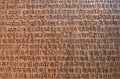 Background with ancient sanskrit text etched into a stone tablet Royalty Free Stock Photo