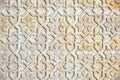 Background in arab style. Texture arabic ornament is yellow. Texture with a pattern of flowers on the stone, close up