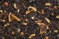 Background of aroma black tea leaves with dried citrus slices and peel. Dry black tea texture Royalty Free Stock Photo