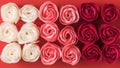 Background of artificial rose buds of three colors