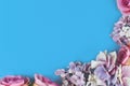 Background with artificial textile hydrangea flowers in lower right corner and blue copy space Royalty Free Stock Photo