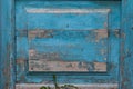 Background as part of an old wooden door with peeling blue paint