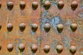 Background asset colorful rivets on industry iron metal corroding with flaking yellow rusty decay