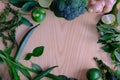 Background with assorted green vegetables of broccoli, ginger, lime, avocado