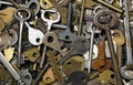 Background of assorted old multi-colored metal antique keys of different shapes. Home security concept. Royalty Free Stock Photo