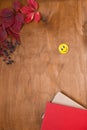 Background of autumn yellow leaves and smiley and books