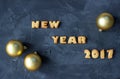 Background with baked gingerbread words happy new year 2017 and christmas balls. creative idea