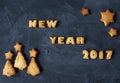 Background with baked gingerbread words new year 2017 with star-shaped and christmas tree - shaped biscuits. creative