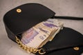 hand bag ,purse with UK pounds banknotes background. Money of United Kingdom