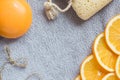 Background for bathing theme: the orange soap, the slices of orange and the bath sponge on the bath towel Royalty Free Stock Photo