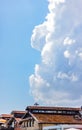 Cloud in the sky in a beautiful bright day with roof tops in the bottom