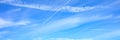 background of beautiful bright blue day sky with white cloud and trail from the plane. banner. Royalty Free Stock Photo