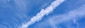 Background of beautiful bright blue day sky with white cloud and trail from the plane. banner. Royalty Free Stock Photo