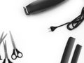 background for beauty clippers scissors and combs are laid around the place for text