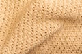 background in beige colored structure of a knitted fabric