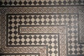 A background with black grey and white masaic tiles on a floor with patterns and space fot tekst Royalty Free Stock Photo