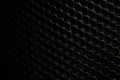 The background of the black plastic net in the dark Copy it as a designer backdrop. Royalty Free Stock Photo