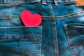 On the background of blue jeans, a red heart in the back pocket, the concept of love relationships Royalty Free Stock Photo