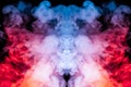 A background of blue, red and purple wavy smoke in the shape of a ghost`s head or a man of mystical appearance on a black isolate