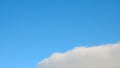 Background of blue sky with cloud in bottom corner. Royalty Free Stock Photo