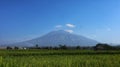 Background of blue sky and Mount Arjuna. Location in Malang City, East Java, Indonesia. Royalty Free Stock Photo