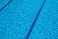 Background of a blue tiled pool with clear cool rippling water Royalty Free Stock Photo