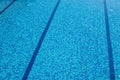 Background of a blue tiled pool with clear cool rippling water Royalty Free Stock Photo