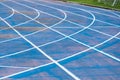 background of blue track for running competition at stadium, focus on center Royalty Free Stock Photo