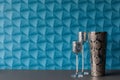 A background with blue wallpaper - colorful space. Silver decorations for an apartment. Two candlesticks on tall legs with a Royalty Free Stock Photo