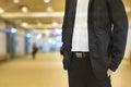 Background blur color tone warm in the morning. Foreground is a man wearing a black suit. Royalty Free Stock Photo