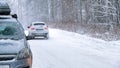 Background, blur, out of focus, sideways. A car during a snowstorm on the road with its headlights on. Winter, snow Royalty Free Stock Photo