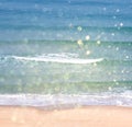 Background of blurred beach and sea waves with bokeh lights, vintage filter. Royalty Free Stock Photo