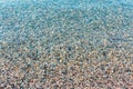 Background of blurred bright colorful sea stones under water. Iridescent sunlight on the stones. Toned photo