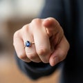 The background is blurred emphasizing the focus on the hand and ring Royalty Free Stock Photo