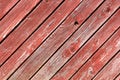 The background of the boards is painted with an old red color. Old red wooden board doors Royalty Free Stock Photo