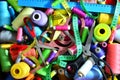 Background of bobbins with multicolored threads for sewing. Needlework, sewing and tailoring concept. Royalty Free Stock Photo