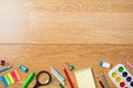 Background with bottom border made of stationery, school supplies on wooden table. Education, studying and back to school concept Royalty Free Stock Photo