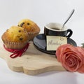 Background with breakfast items, small cup, two muffins, a rose Royalty Free Stock Photo