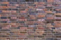 Background, brick wall made old German red burnt brick with traces bullets and shrapnel after World War II. Royalty Free Stock Photo