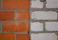 Background of a brick wall where half is lined with red brick and half is white. A brick of rare stones divides the wall Royalty Free Stock Photo