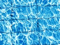 Background of bright blue clear water in the pool