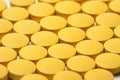 Background of bright yellow round tablets medical