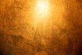Background with a bronze or golden scratched surface with a highlight at the top center Royalty Free Stock Photo